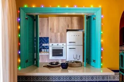 a kitchen with an open door into a kitchen at Castle Holiday Apartments in Limassol