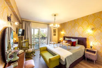 a bedroom with a bed and a living room at Castle Holiday Apartments in Limassol