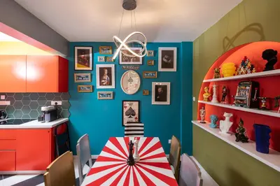 a kitchen with a table with a red and blue wall at Castle Holiday Apartments in Limassol