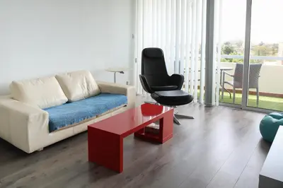 a living room with a couch and a chair at Salt Lake view Apartment in Larnaka