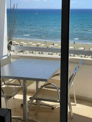 a table and chairs with a view of the beach at Alex Beach Apartment 31 in Larnaka