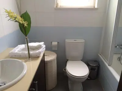 a bathroom with a white toilet and a sink at Panorama Luxury Villa in Protaras