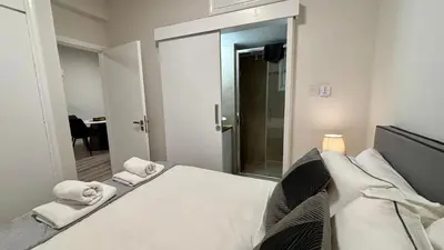 a bedroom with a bed with towels on it at SeaBreeze City Center Flats by TrulyCyprus in Limassol