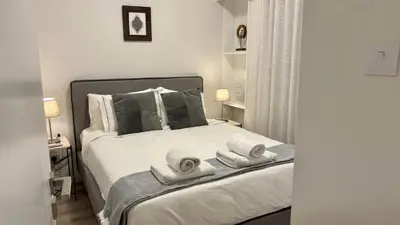 a bedroom with a bed with towels on it at SeaBreeze City Center Flats by TrulyCyprus in Limassol