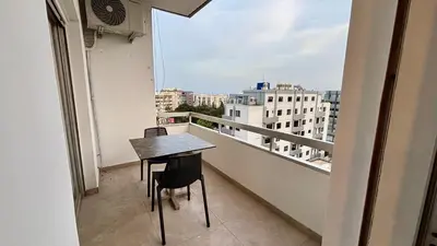 a table and chairs on a balcony with a view at SeaBreeze City Center Flats by TrulyCyprus in Limassol