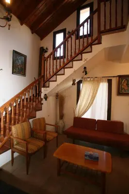 a living room with a couch and a staircase at Villa Vasa in Vasa Kilaniou