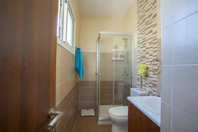 a bathroom with a shower and a toilet and a sink at Protaras Villa Anemoni 6 in Protaras
