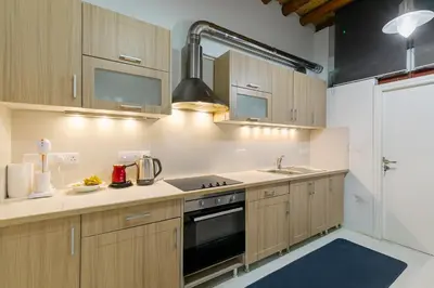 a kitchen with wooden cabinets and a stove top oven at Annis House in Kato Lefkara