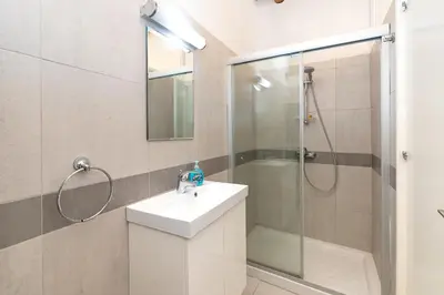 a bathroom with a shower and a sink and a mirror at Annis House in Kato Lefkara