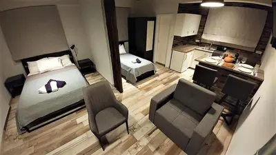 an overhead view of a bedroom with a bed and a chair at Perneia Rooms in Askas