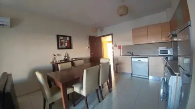 a kitchen and dining room with a table and chairs at Pyla Gardens D5 in Pyla