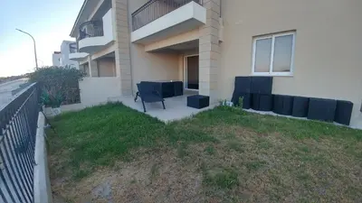 a chair sitting outside of a building at Pyla Gardens D5 in Pyla
