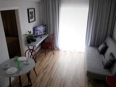 a living room with a couch and a table at Pasithea Holiday Apartments in Larnaka