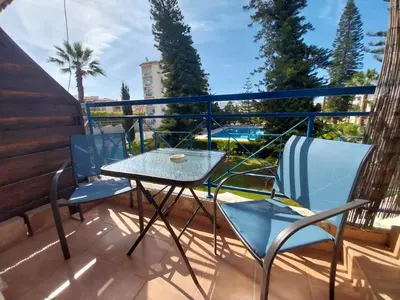 a patio with two chairs and a table on a balcony at Palm Beach Apartment 26 in Limassol