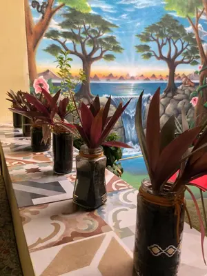 a table with three vases with plants on it at Zouglas App Guesthouse in Limassol