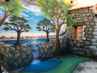 a wall with a painting of trees and a waterfall at Zouglas App Guesthouse in Limassol