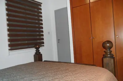 a bedroom with a bed and a dresser and a window at Apartment Ground Floor, FREE INTERNET in Ayia Napa