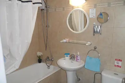 a bathroom with a sink and a toilet and a bath tub at Apartment Ground Floor, FREE INTERNET in Ayia Napa