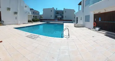 a swimming pool in the middle of a courtyard at Apartment Ground Floor, FREE INTERNET in Ayia Napa