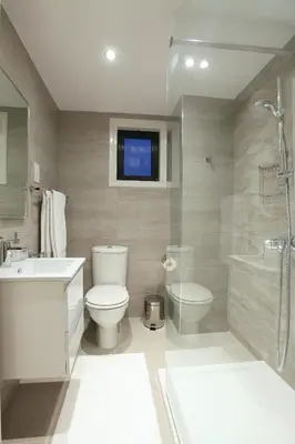 a bathroom with a toilet and a sink and a shower at Green Bay Villa in Protaras