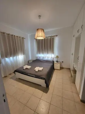 a bedroom with a bed with two towels on it at Villa Gracia in Ayia Napa