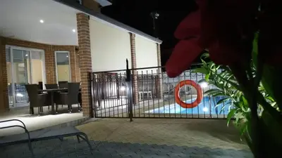 a house with a gate with a swimming pool at Panais Villa in Kiti