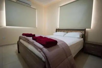 a bedroom with a bed with red towels on it at Panais Villa in Kiti