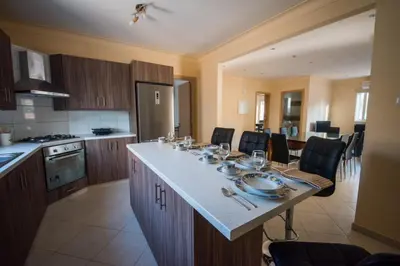a kitchen with a large island with a table in it at Panais Villa in Kiti