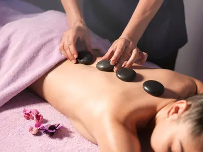 a woman getting a massage from a therapist at St Raphael Resort in Limassol
