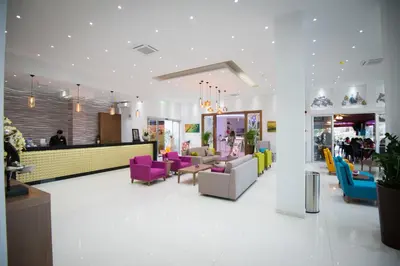 a lobby with colorful chairs and a counter at Loutsiana Deluxe Apts in Ayia Napa