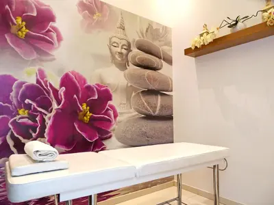 a bathroom with a wall with a mural of a buddha at Loutsiana Deluxe Apts in Ayia Napa