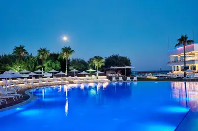 a large pool with chairs and umbrellas in a resort at So Nice Beach Resort in Ayia Napa