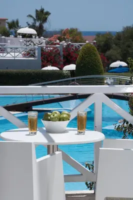 a bowl of fruit on a table next to a pool at So Nice Beach Resort in Ayia Napa