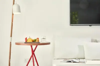 a table with fruit on it next to a bed at So Nice Beach Resort in Ayia Napa