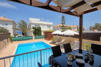 a balcony with a swimming pool in a house at myExclusiveVilla 683 in Protaras