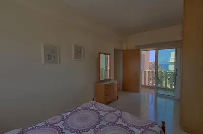 a bedroom with a bed and a door to a balcony at myExclusiveVilla 683 in Protaras