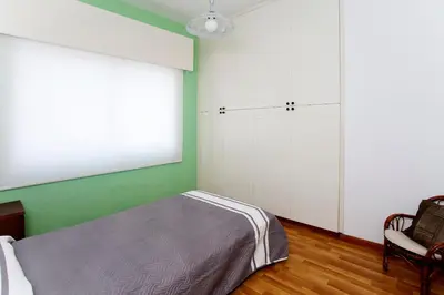 a bedroom with a bed and a chair at Despoina Town House in Limassol