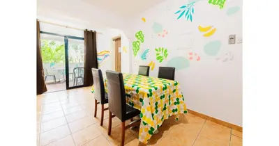 a dining room table and chairs with a colorful table cloth at Urban Stays in Ayia Napa
