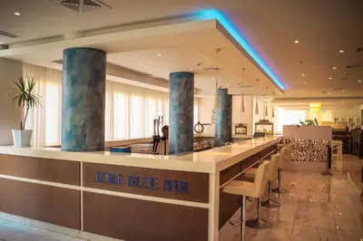 a bar in a restaurant with a blue bar at Gaia Sun N Blue Hotel in Ayia Napa