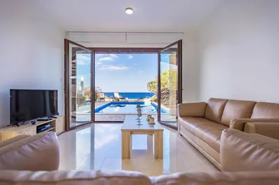 a living room with a couch and a tv at Greko Mare Front Line in Protaras