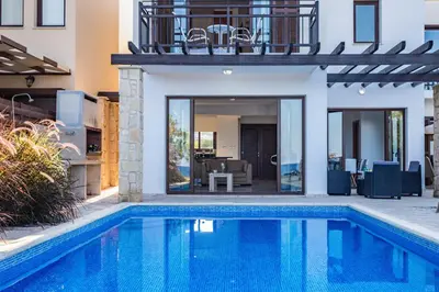 a villa with a swimming pool and a house at Greko Mare Front Line in Protaras