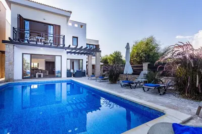 a villa with a swimming pool and a house at Greko Mare Front Line in Protaras