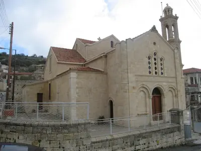 a large stone church with a tower and a steeple at Arsos Village Apartment in Arsos