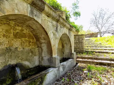 an old stone bridge with stairs next to it at Arsos Village Apartment in Arsos