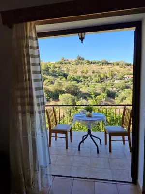 a patio with a table and chairs on a balcony at Arsos Village Apartment in Arsos