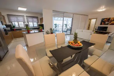 a living room with a table with a bowl of fruit on it at Skylight Megaron in Larnaka