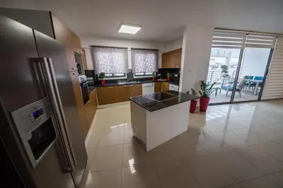 a kitchen with a refrigerator and a counter top at Skylight Megaron in Larnaka
