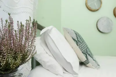 a bunch of pillows on a table with a vase of flowers at To Konatzi tis Marikas tzai tou Yianni in Kato Drys