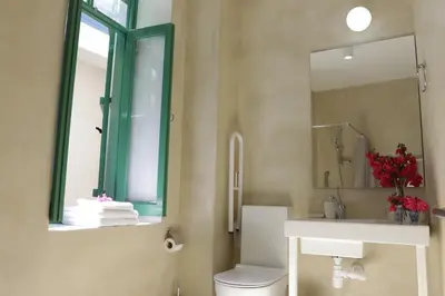 a bathroom with a toilet and a sink and a mirror at To Konatzi tis Marikas tzai tou Yianni in Kato Drys