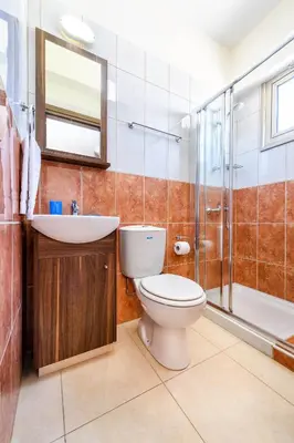 a bathroom with a toilet and a sink and a shower at Villa Marizan in Protaras